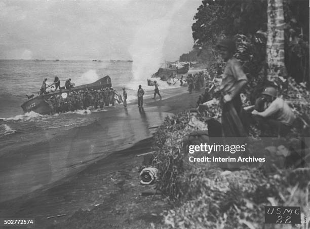 View, along the beach, of US Marines as they attempt relaunch beached landing craft, Bougainville Island, Papua New Guinea, 1943.