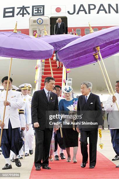 Emperor Akihito and Empress Michiko of Japan are welcomed by Crown Prince Maha Vajiralongkorn of Thailand on arrival at the Don Mueang International...