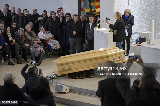 Kabyle singer Idir performs with a guitar during a ceremony to pay tribute to late Algerian opposition figure Hocine Ait-Ahmed, on December 29, 2015...