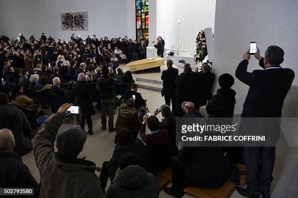 Kabyle singer Idir performs with a guitar during a ceremony to pay tribute to late Algerian opposition figure Hocine Ait-Ahmed, on December 29, 2015...