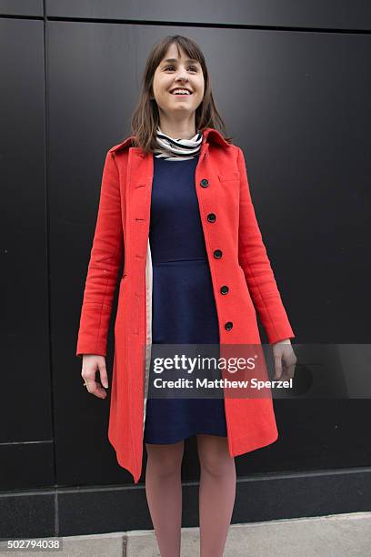 Andi Mariategui is seen on Michigan Avenue wearing taupe Madewell boots and a navy blue Madewell dress, orange-red J.Crew jacket and striped J.Crew...