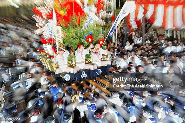 The third float 'Daikoku-Nagare' rushes through Seido Street of Kushida Jinja Shrine during the Hakata Gion Yamakasa festival on July 15, 2006 in...