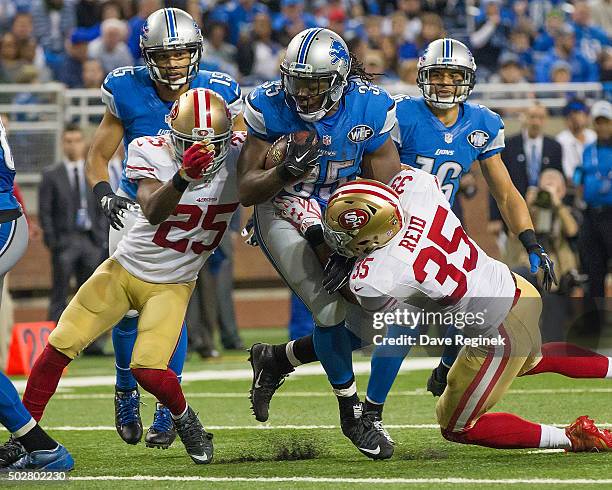 Joique Bell of the Detroit Lions tries to run between Jimmie Ward and Eric Reid of the San Francisco 49ers during an NFL game at Ford Field on...