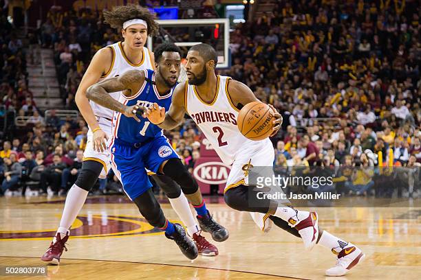 Tony Wroten of the Philadelphia 76ers guards Kyrie Irving of the Cleveland Cavaliers during the first half at Quicken Loans Arena on December 20,...