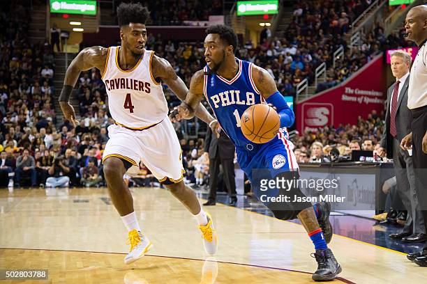 Iman Shumpert of the Cleveland Cavaliers guards Tony Wroten of the Philadelphia 76ers during the first half at Quicken Loans Arena on December 20,...