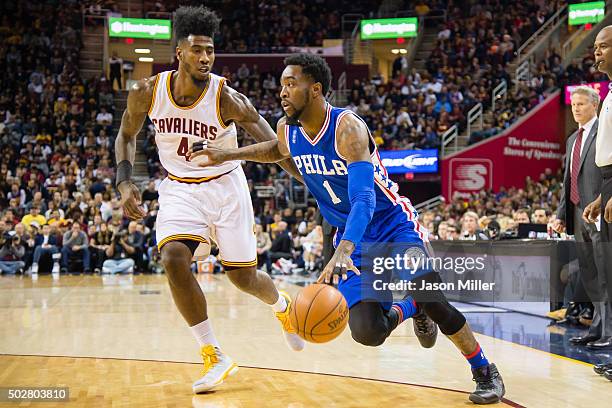 Iman Shumpert of the Cleveland Cavaliers guards Tony Wroten of the Philadelphia 76ers during the first half at Quicken Loans Arena on December 20,...