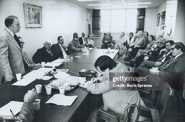 View of boardroom with some board members and Miller during their meeting.