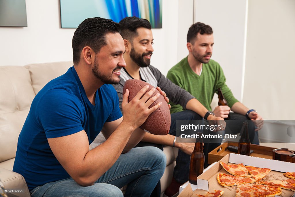 Young friends watching a football game
