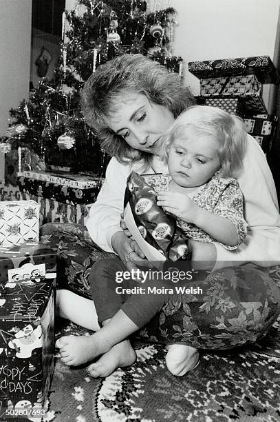 Mixed Blessings: Keri Lee Deon; mother of slain Kayla Klaudusz shows 2-year-old daughter Brittany some of the presents awaiting her under the...