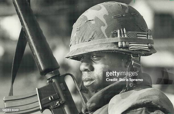 Grenada Guard; A U.S. Marine stands guard at one of the main bridges on the road leading to St. George's during the American invasion of Grenada.