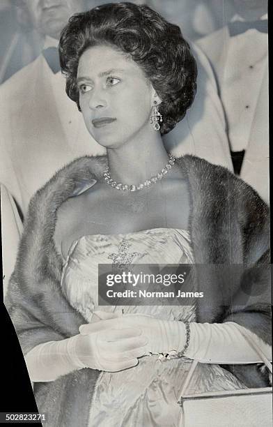 She wore a full-length evening gown of rose silk-taffeta with a large sparkling diamond brooch and a mutation mink stole. Most of the women in the...