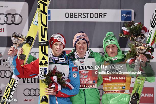 Michael Hayboeck of Austria, Severin Freund of Germany and Peter Prevc of Slovenia pose at the podium after Day 2 of the 64th Four Hills Tournament...
