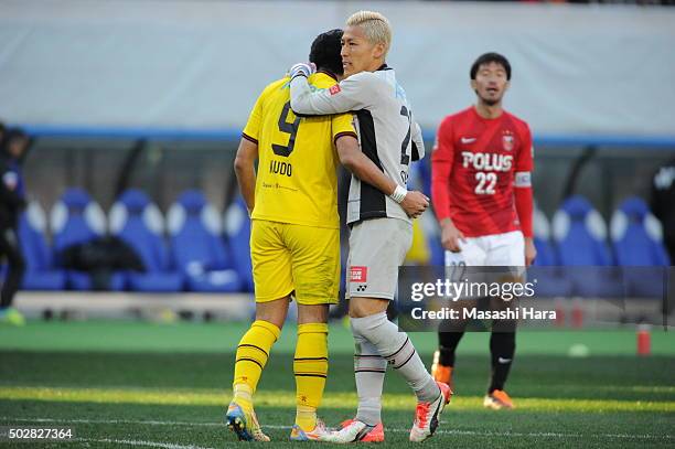 Takanori Sugeno of Kashiwa Reysol hugs Masato Kudo after the 95th Emperor's Cup semi final match between Urawa Red Diamonds and Kashiwa Reysol at...