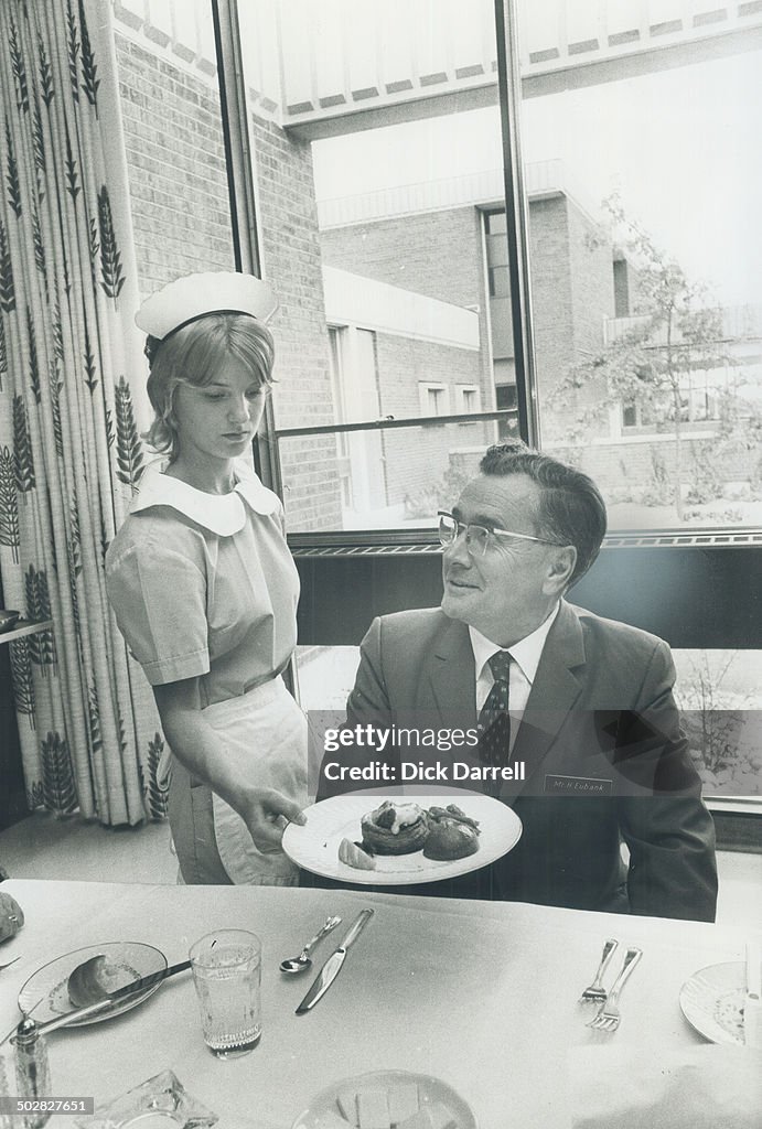 Principal Howard L. Eubank has his dinner served in staff dining room by students waitress Denise Po