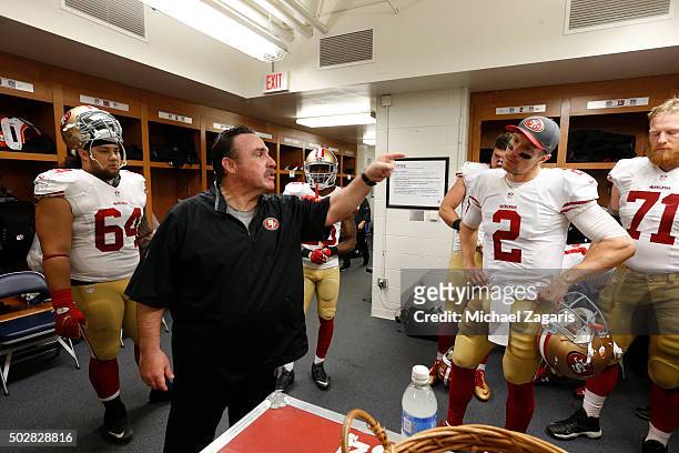 Head Coach Jim Tomsula of the San Francisco 49ers addresses the team in the locker room during halftime of the game against the Detroit Lions at Ford...
