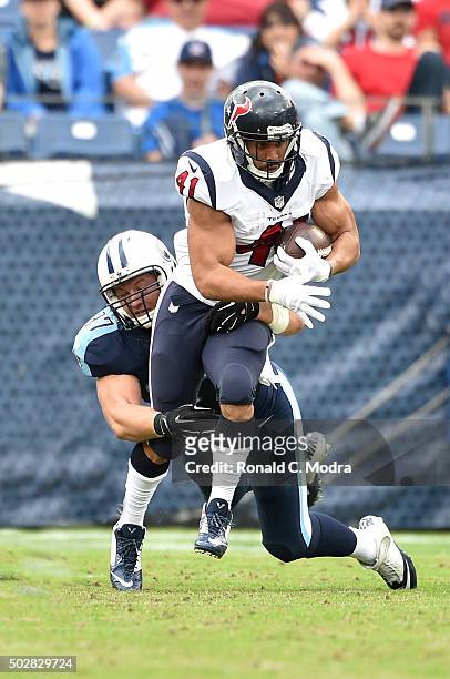 Running back Jonathan Grimes of the Houston Texans carries the ball against the Tennessee Titans during a NFL game at Nissan Stadium on December 27,...