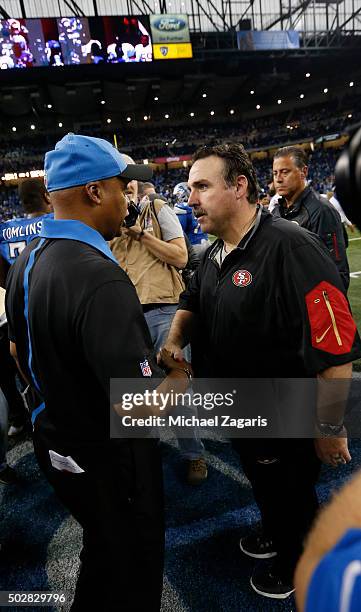 Head Coach Jim Caldwell of the Detroit Lions and Head Coach Jim Tomsula of the San Francisco 49ers talk on the field following the game at Ford Field...