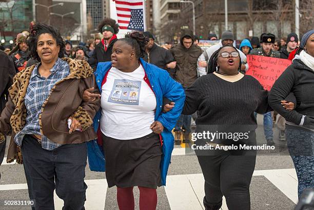 Activists lock arms and march down E. 9th St. On December 29, 2015 in Cleveland, Ohio. Protestors took to the street the day after a grand jury...