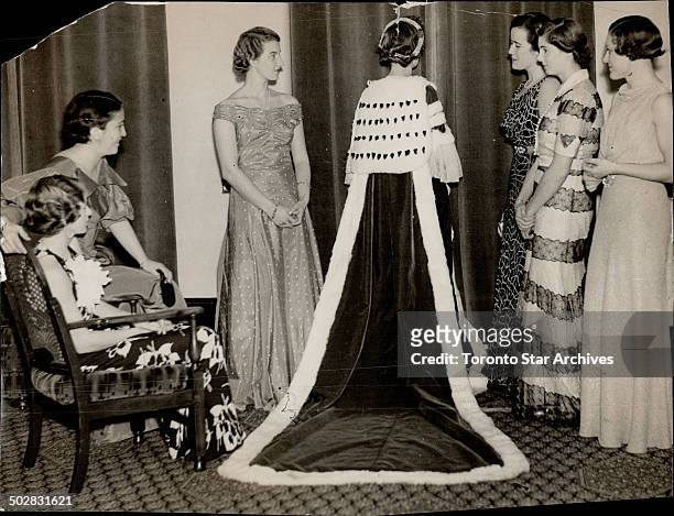 Six stars of the tennis court display court robes to be worn at the coronation of King George VI next May. The young ladies are Freda James; Anita...