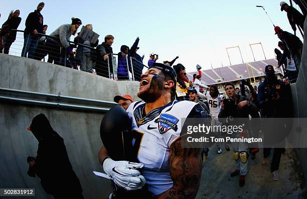 Daniel Lasco of the California Golden Bears celebrates with the championship trophy after beating the Air Force Falcons 55-36 in the Lockheed Martin...