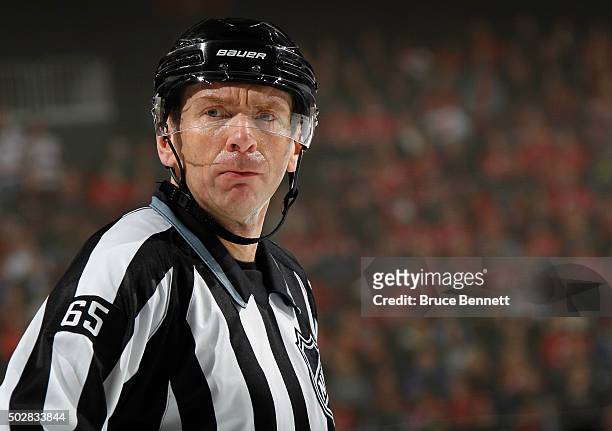 Linesman Pierre Racicot waits for a faceoff between the New Jersey Devils and the Carolina Hurricanes at the Prudential Center on December 29, 2015...