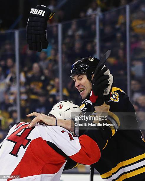 Mark Borowiecki of the Ottawa Senators and Zdeno Chara of the Boston Bruins exchange punches during the second period at TD Garden on December 29,...