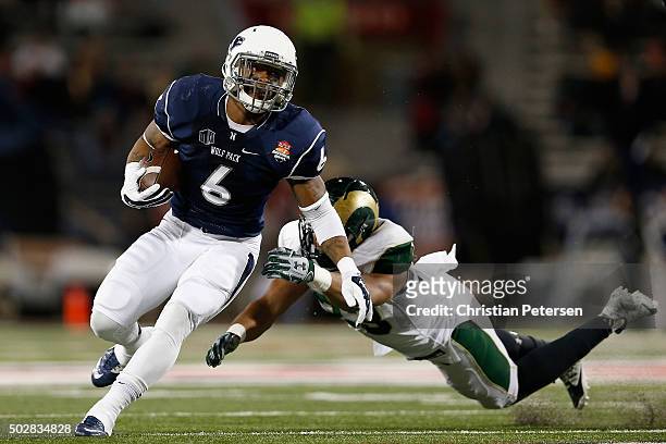 Running back Don Jackson of the Nevada Wolf Pack rushes the football past linebacker Kevin Davis of the Colorado State Rams during the second quarter...