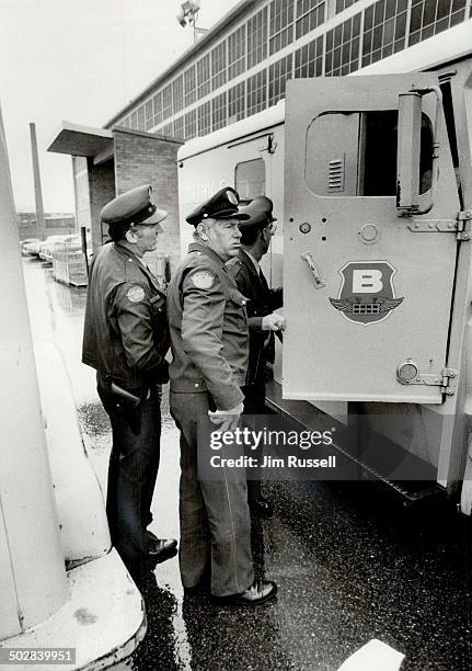 Supermarket holdup: Brink's guards Doug Janes; left; and Claude LeClerc; who had a gun pointed at his face; were robbed yesterday of $153;000 in the...