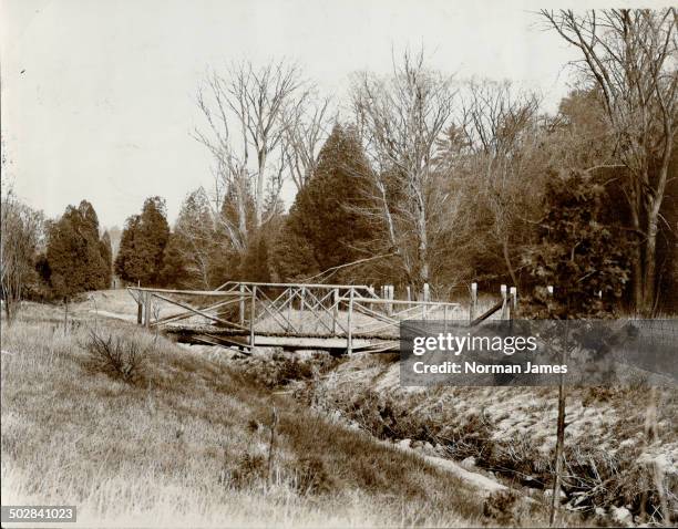 Sunnybrook farm picturesque rustic bridge over one of she winding creeks.