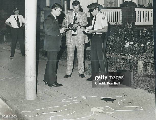 Chalk outlines where body of man shot by a Metro police constable last night lay on Ossington Ave. Sgt. Vaughan O'Toole; Staff Sgt. Jim Newsome and a...