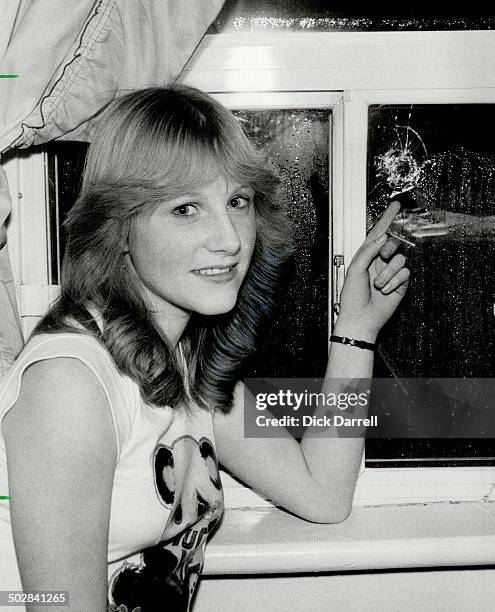 Bullet in bedroom: Thirteen-year-old Susan Hall points to the bullet hole in her bedroom window on Lansdowne Ave.