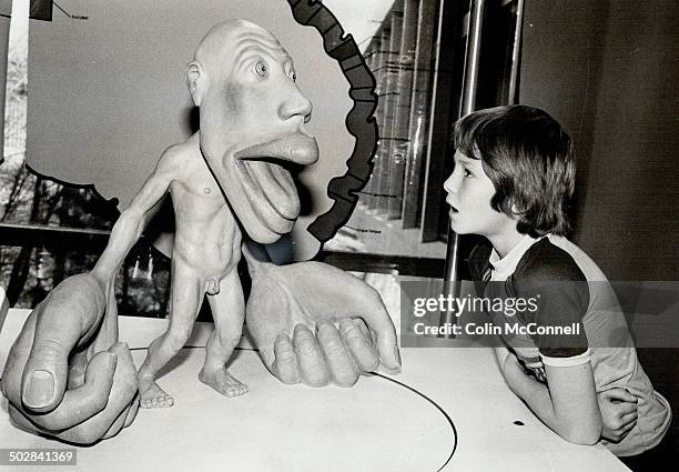 Say Aahl: David Bourne; 11; gazes at the homunculus in the Seeing Brain display at the Ontario Science Centre. The parts of the man's figure are in...