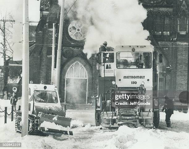 Machine that scoops snow up from the Street; melts it ans spews the water out into the gutter goes into action yesterday on Adelaide St. W. At...