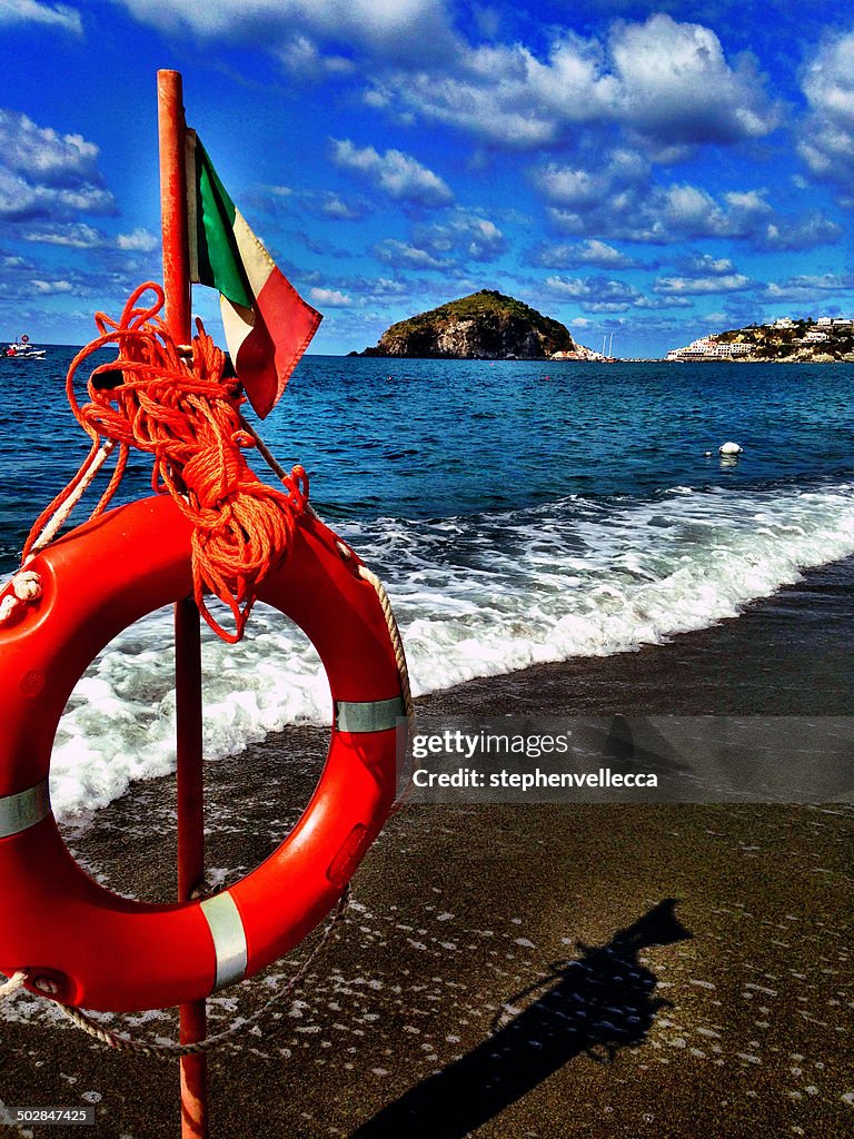 Italy, Ischia, Life preserver on wooden post on beach