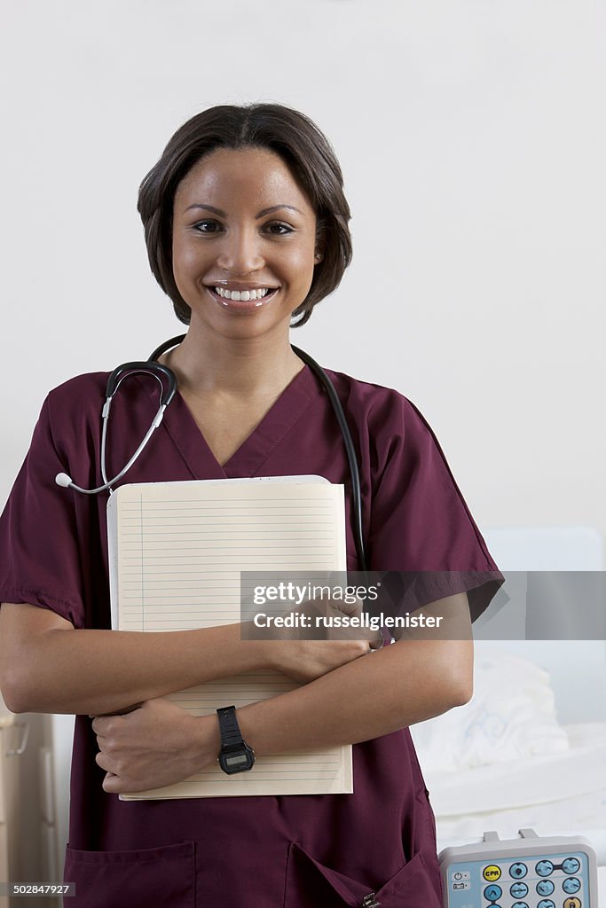 Portrait of smiling nurse holding medical notes