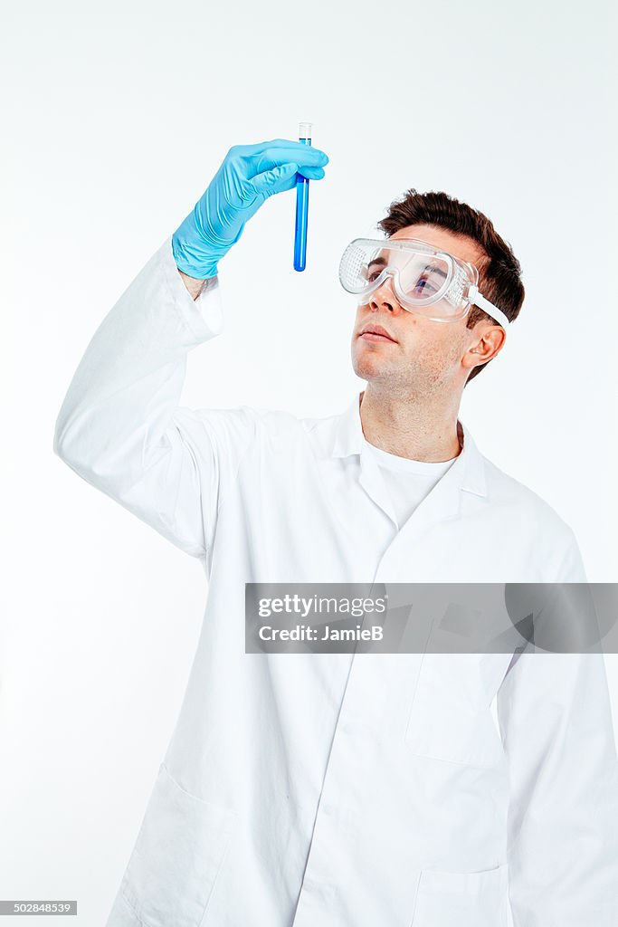 Scientist looking at test tube