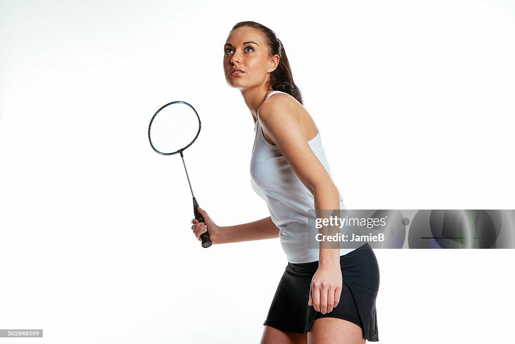 Young woman playing badminton