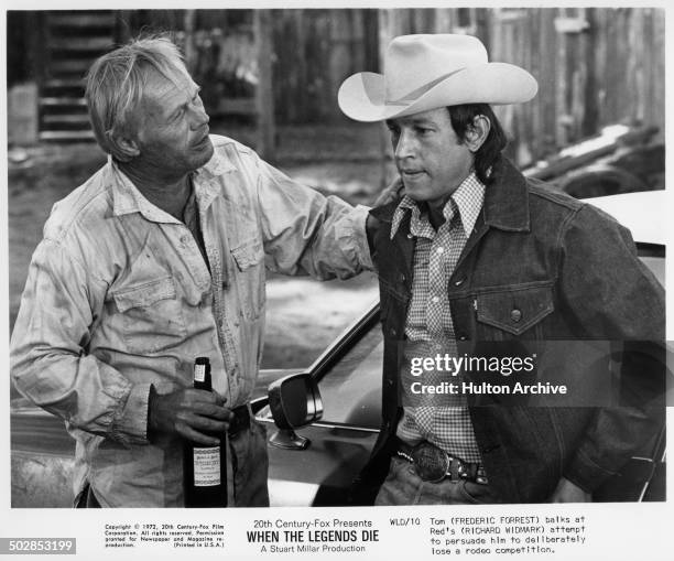 Richard Widmark talks with Frederic Forrest in a scene from the 20th Century Fox movie "When the Legends Die" circa 1971.