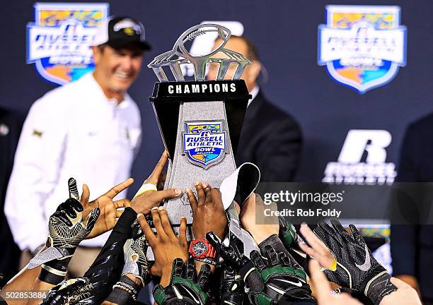 Baylor Bears players hold the chapionship trophy as head coach Art Briles looks on after the Russell Athletic Bowl game against the North Carolina...