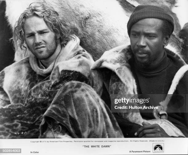 Timothy Bottoms sits with Louis Gossett Jr.in a scene from the Paramount Pictures movie "The White Dawn" circa 1974.