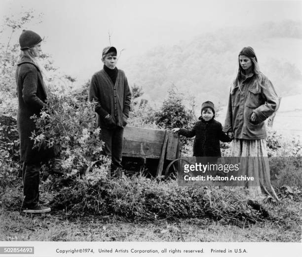 Julie Gholson, Matthew Burrill, Helen Harmon, Jan Smithers stand together in a scene for the United Artist movie "Where the Lilies Bloom" circa 1974.