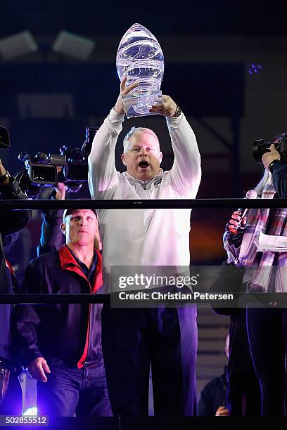 Head coach Brian Polian of the Nevada Wolf Pack holds up the Nova Home Loans Arizona Bowl trophy after defeating the Colorado State Rams 28-23 at...