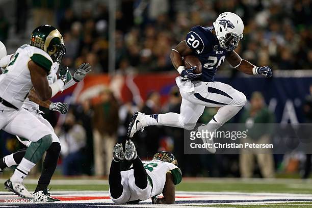 Running back James Butler of the Nevada Wolf Pack leaps over safety Trent Matthews of the Colorado State Rams as he rushes the football during the...