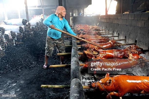 Workers of Laloma in Quezon City are getting busy to cook the ordered Lechon Baboy for the celebration of Noche-Buena or new year celebration,...