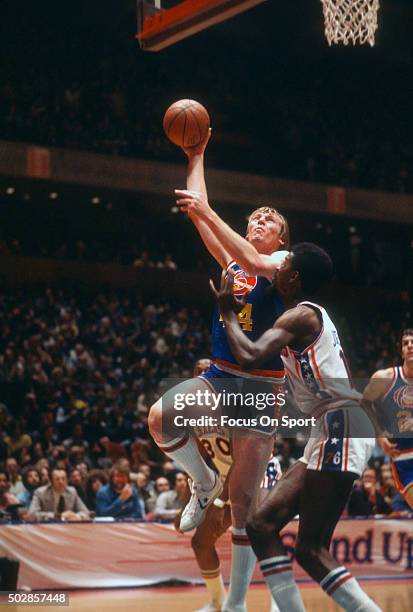 Dan Issel of the Denver Nuggets shoots over Caldwell Jones of the Philadelphia 76ers during an NBA basketball game circa 1977 at The Spectrum in...