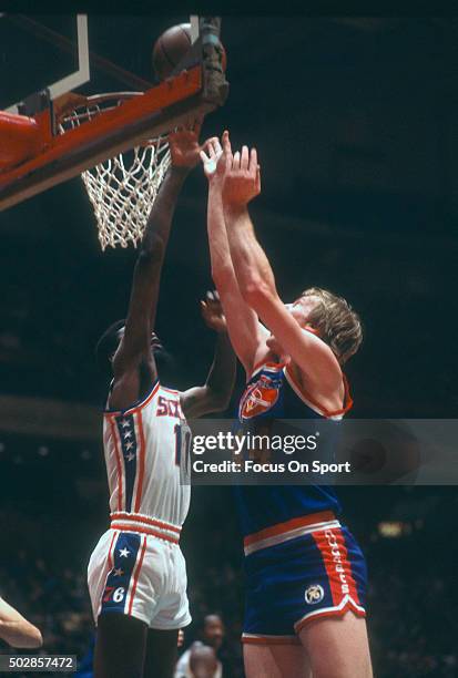 Dan Issel of the Denver Nuggets shoots over Caldwell Jones of the Philadelphia 76ers during an NBA basketball game circa 1977 at The Spectrum in...
