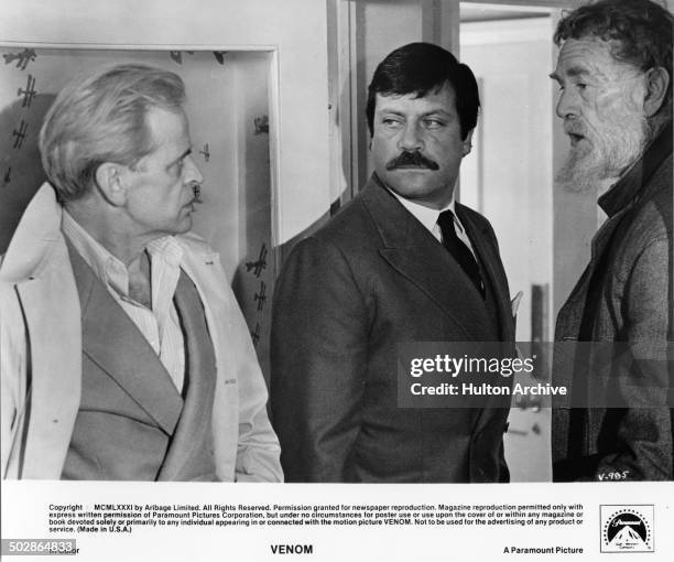 Klaus Kinski ; Oliver Reed Sterling Hayden makes plans in a scene from the Paramount Picture movie "Venom" circa 1981.