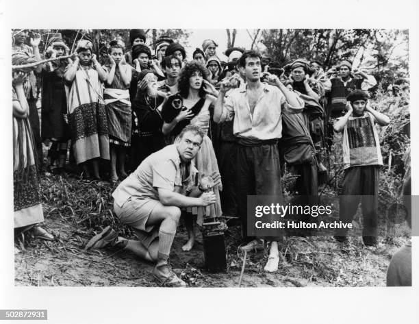 John Candy, Rita Wilson and Tom Hanks plug thier ears in a scene for the TriStar Pictures movie "Volunteers" circa 1984.