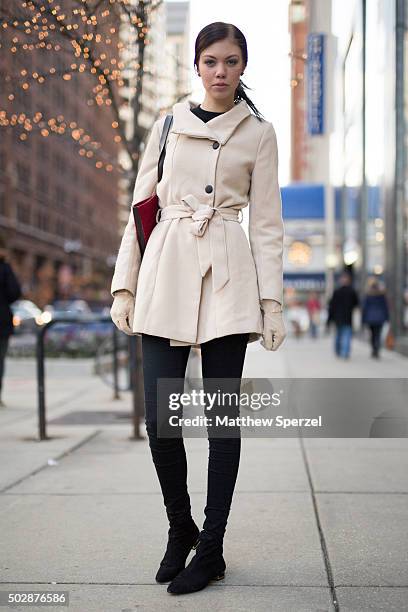 Teresa Eloranta is seen on Michigan Avenue wearing a vanilla vintage coat, black Lindex sweater, red Vero Moda bag, and black Zara shoes on December...