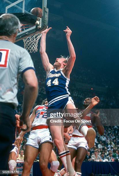 Dan Issel of the Denver Nuggets shoots over Greg Ballard of the Washington Bullets during an NBA basketball game circa 1979 at the Capital Centre in...